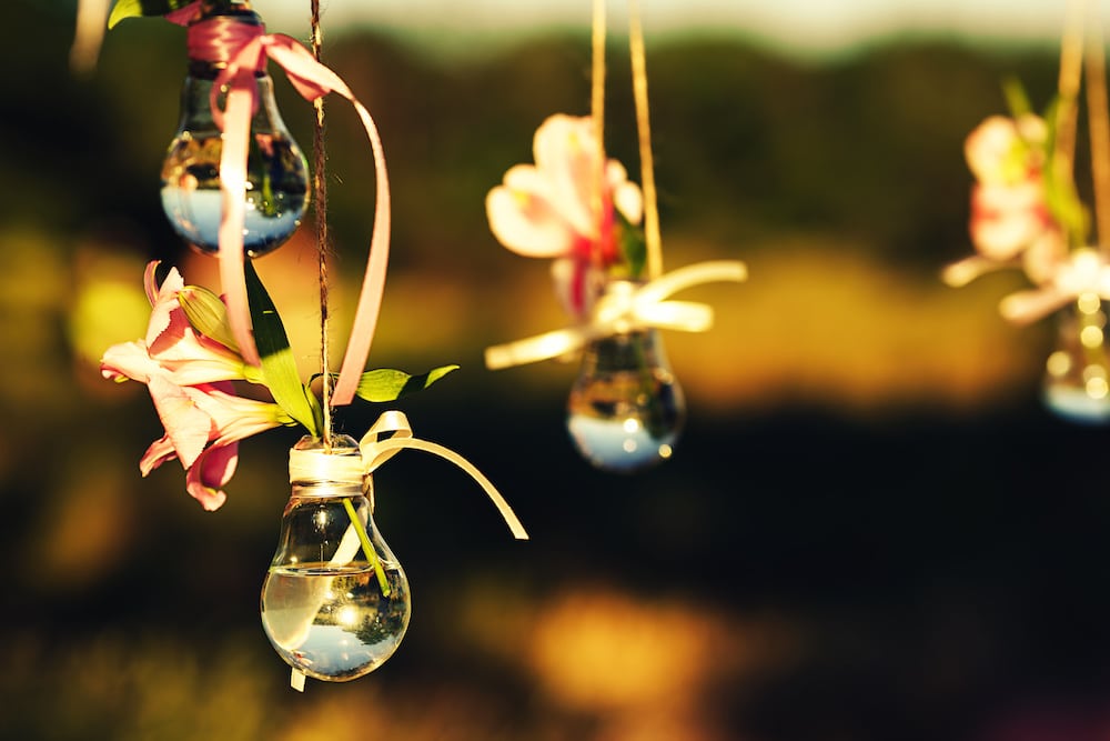 wedding decor hack, flowers in lightbulb vase used as pendant lights