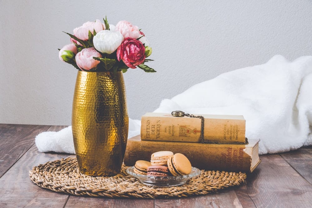 wedding decor hack, centerpiece with books and flowers