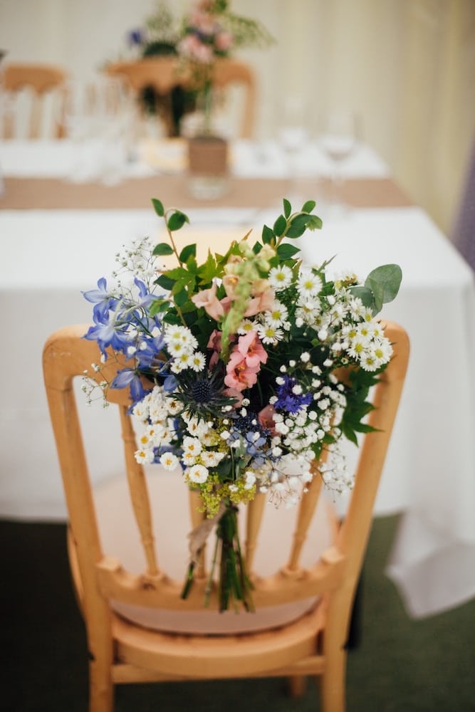 wedding decor hack, flowers tied to chairs