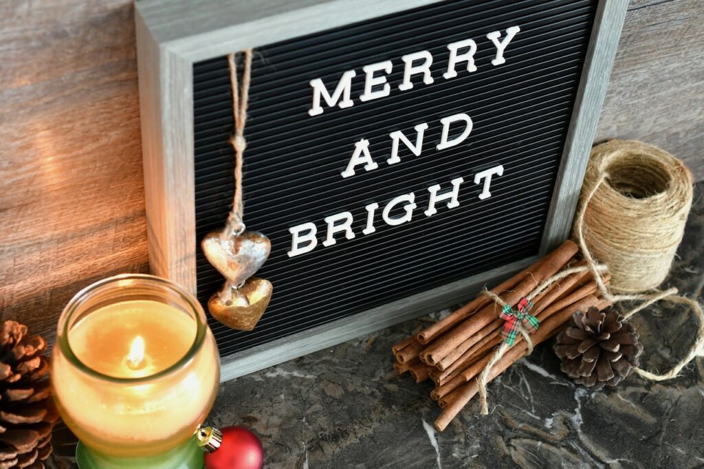 Merry and bright sign with cinnamon and candle