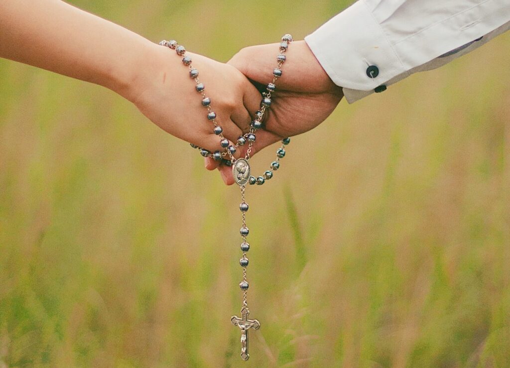couple holding rosary