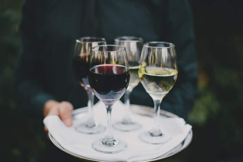 wine glasses being served at wedding
