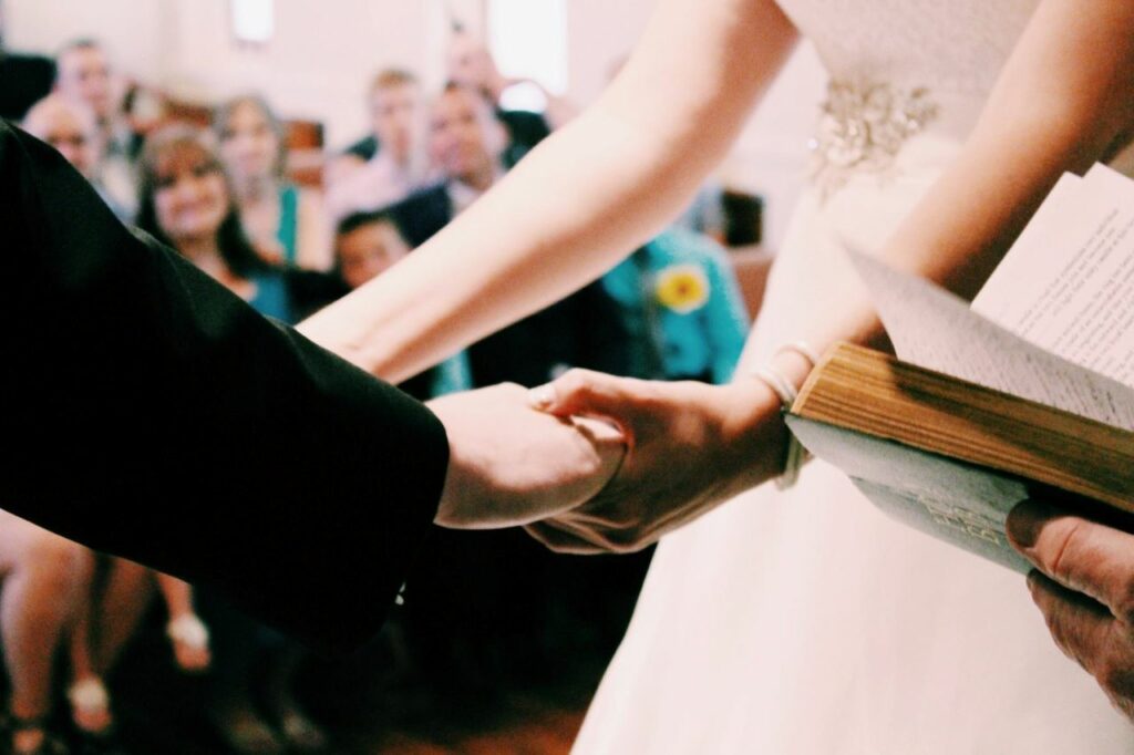 bride and groom holding hands while saying vows
