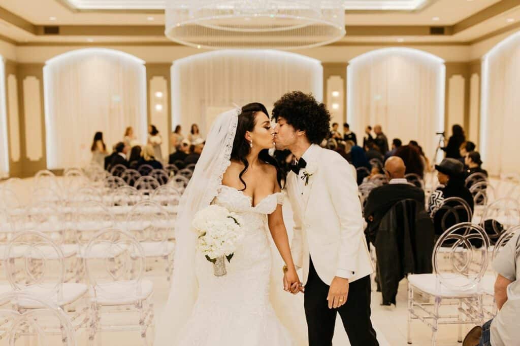 bride and groom kissing at wedding venue