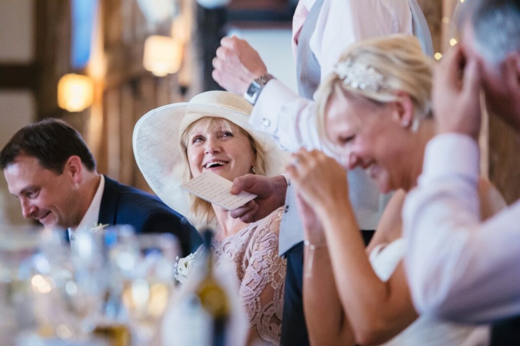 wedding guests laughing at wedding toast