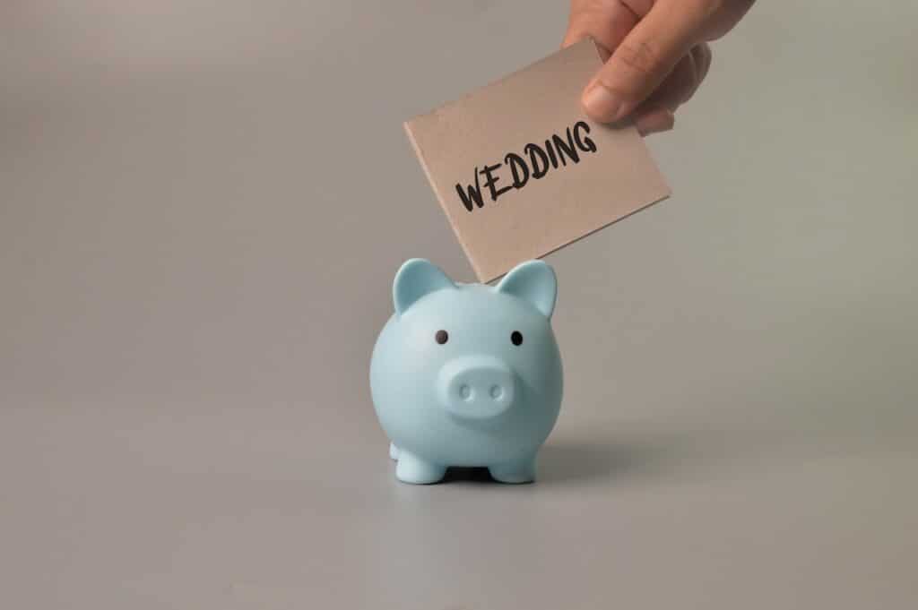 Wedding money being put into a piggy bank.