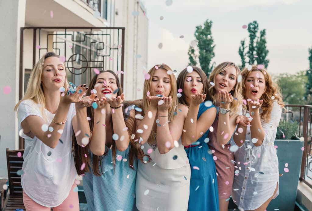 girls blowing confetti 