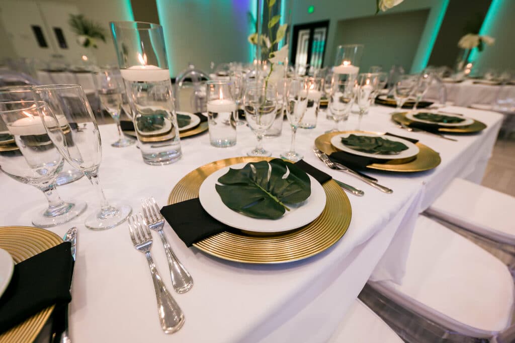 Table set with green leaves on the plates.