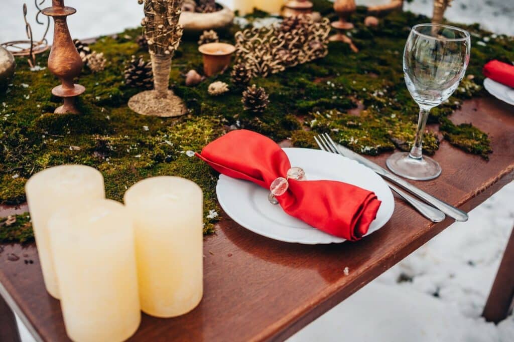 Table and dinnerware set out in the snow.