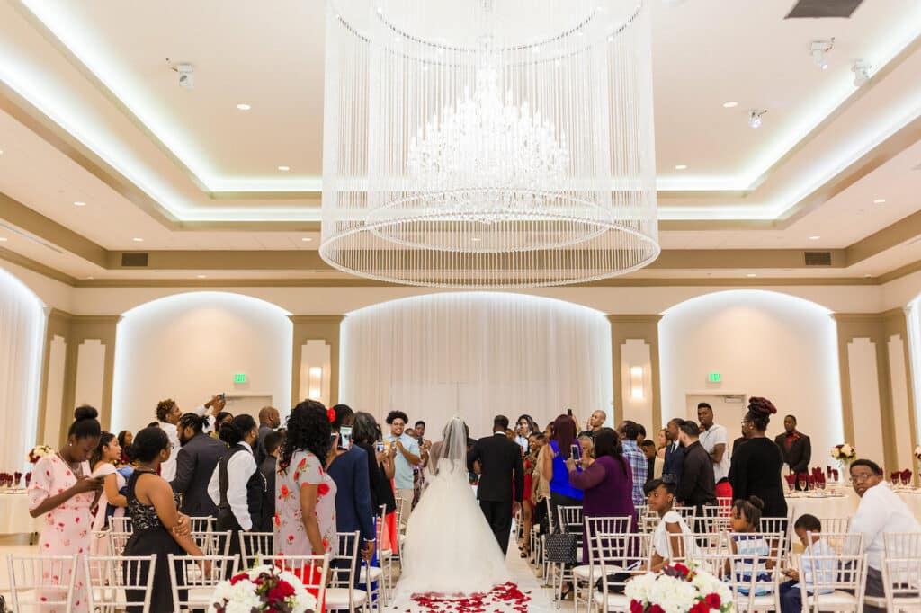 Bride and groom walking down the isle at wedding venue.