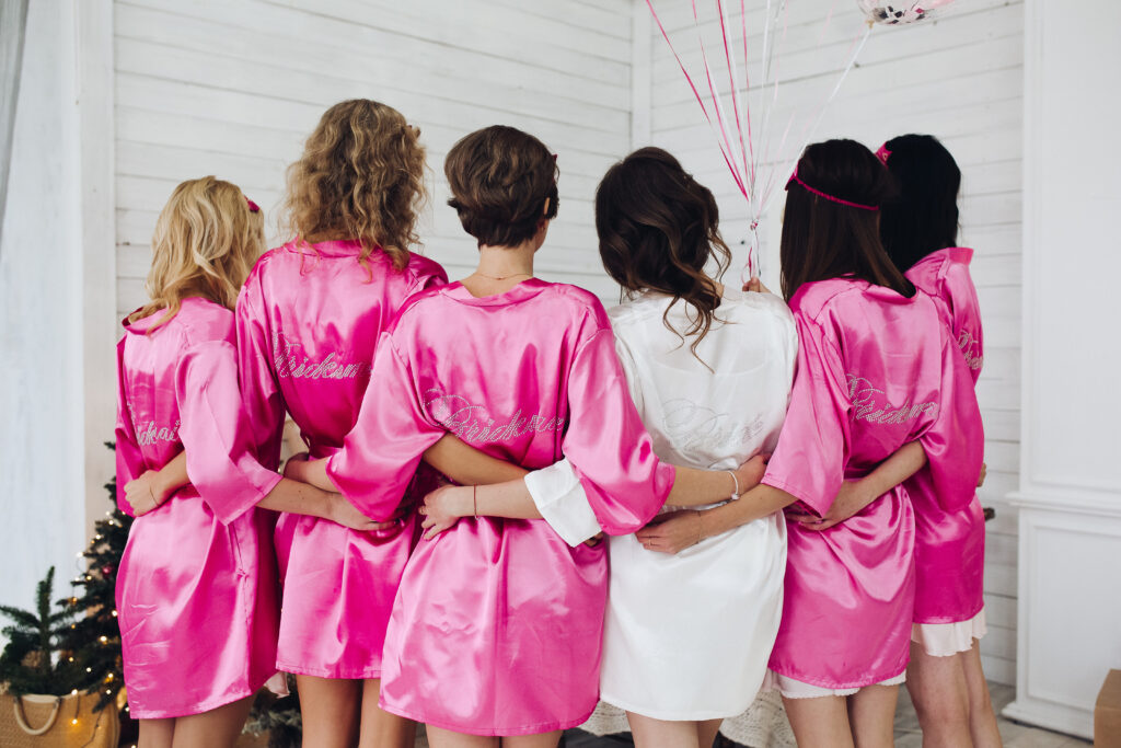 bridal party with the bride in matching silk robes