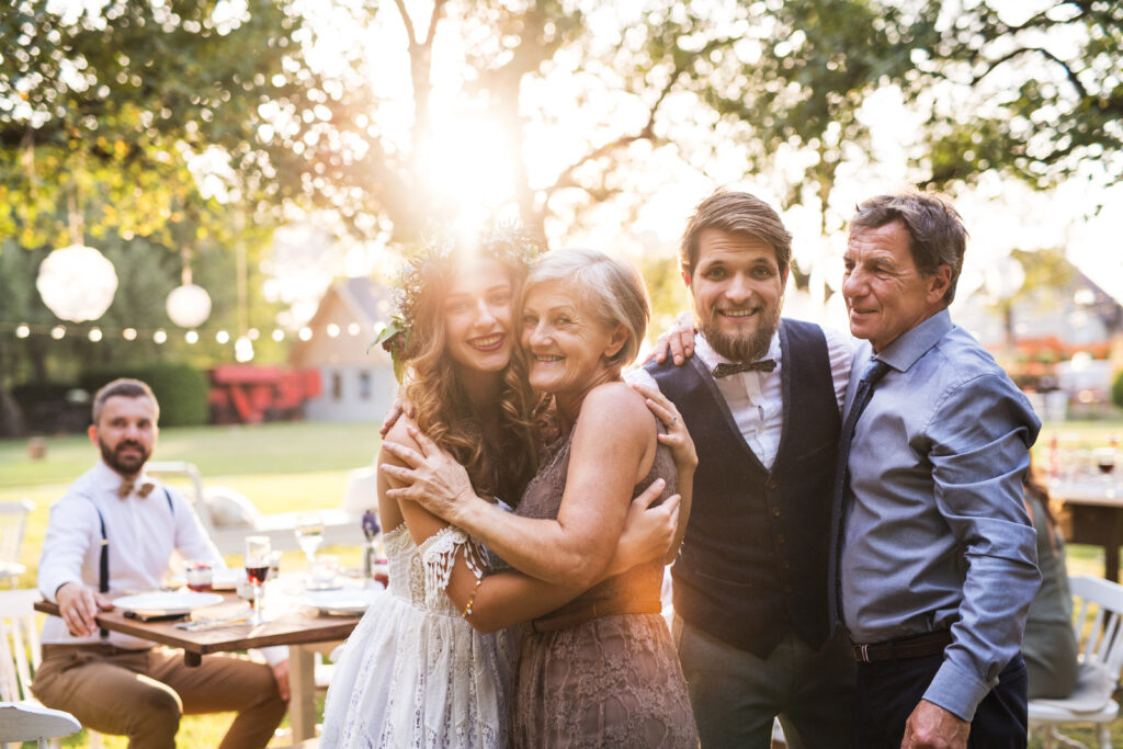 Bride and groom with parents posing for a photo