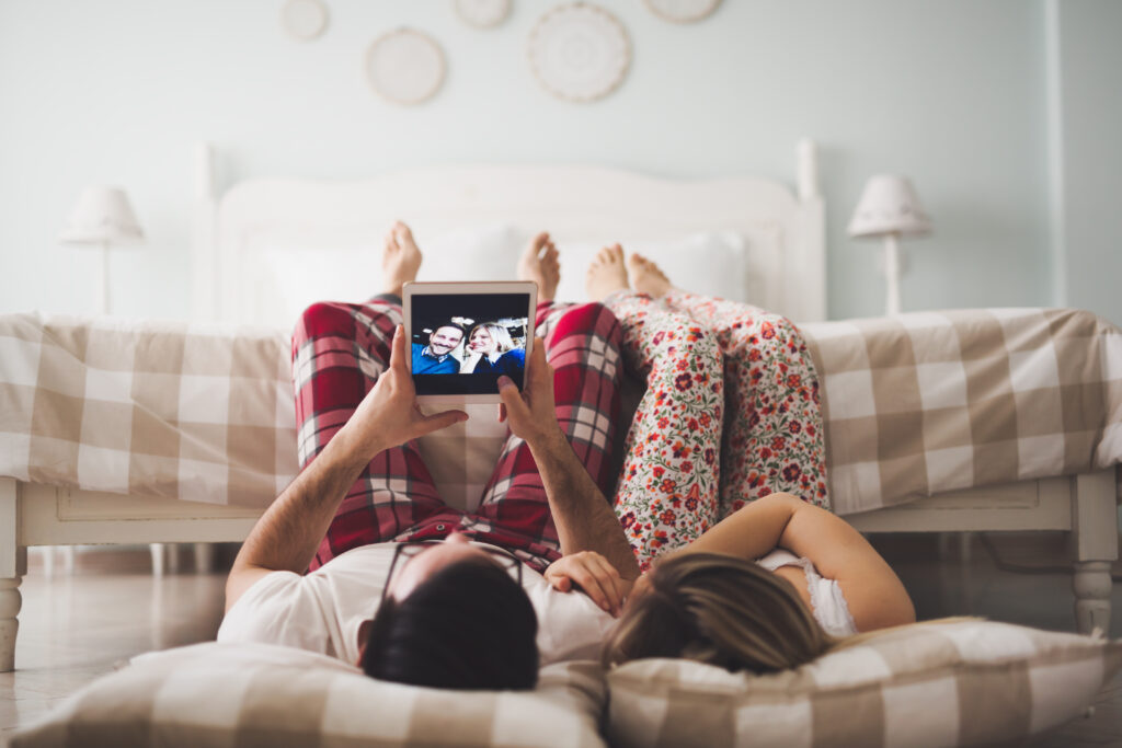 Couple in love looking at photo album on tablet