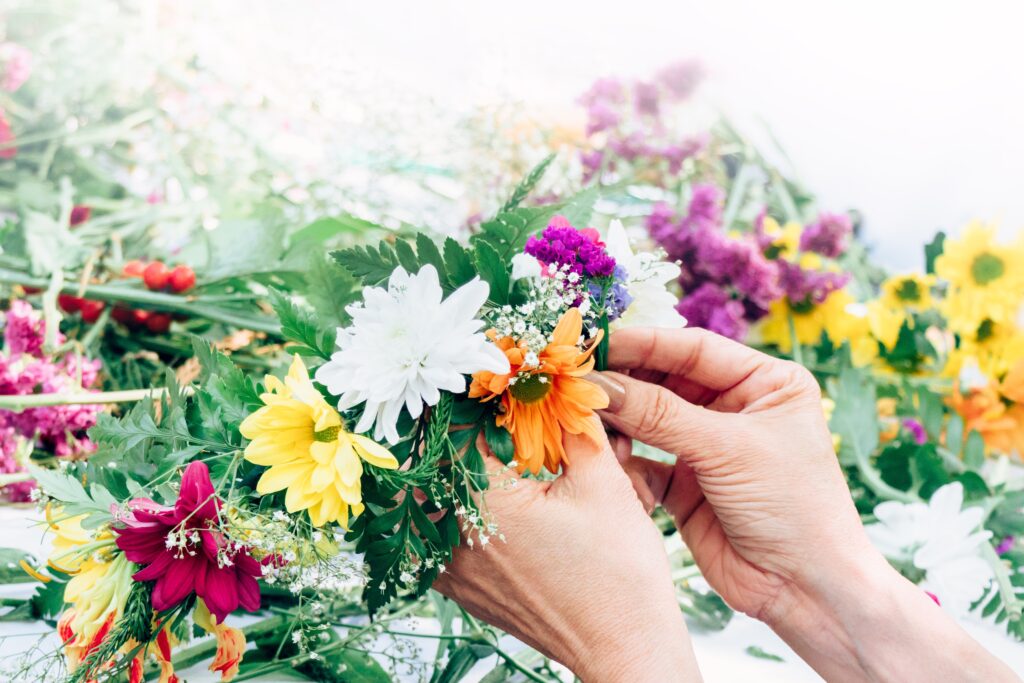 woman creating fresh flower crown