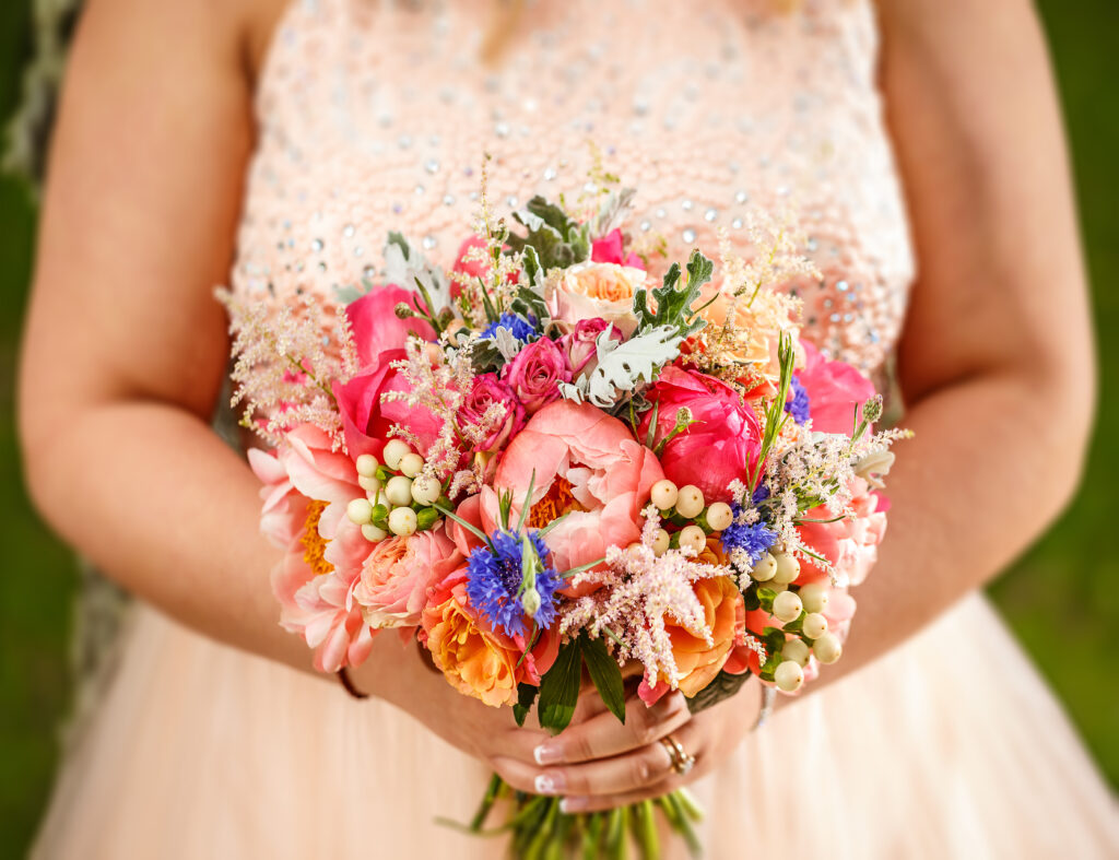 Bride holding vibrant wedding bouquet