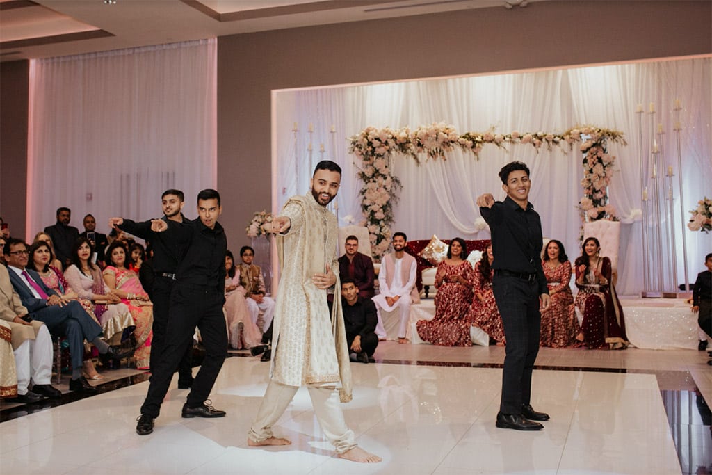 groom dances at Indian wedding celebration