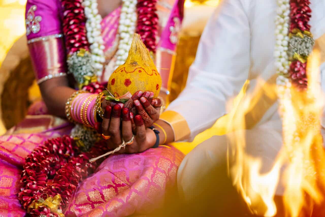 Bride and groom holding hands at traditional Indian wedding ceremony
