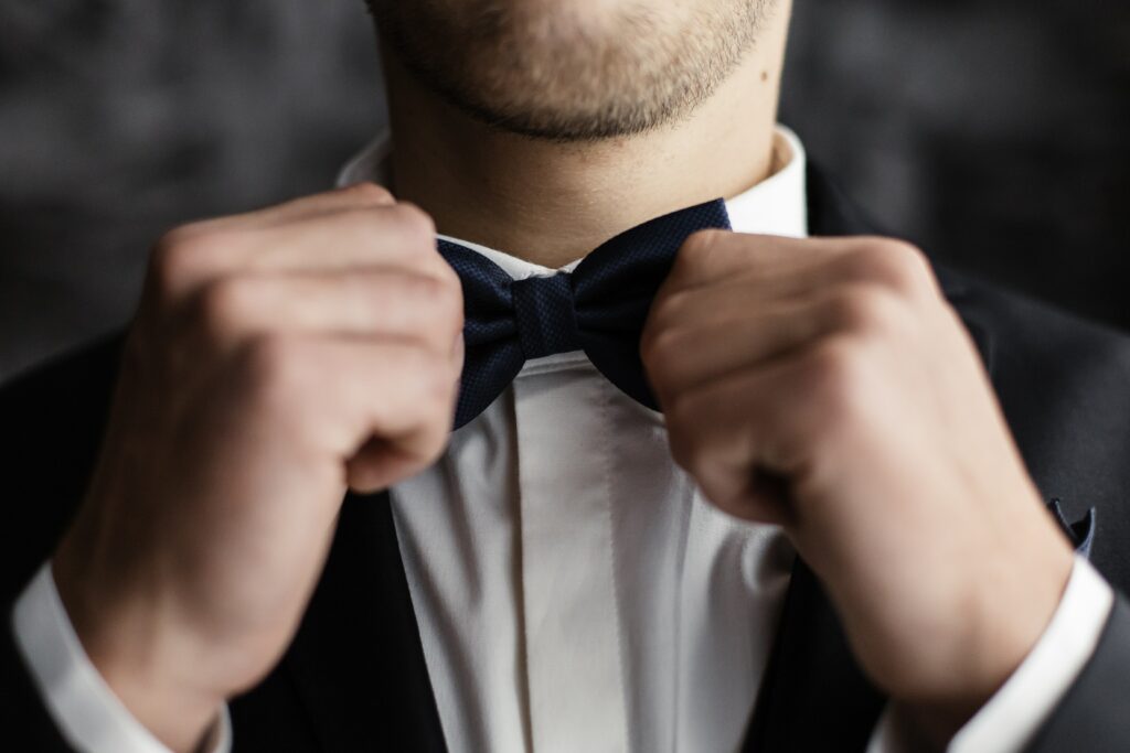 groom fixes his bow tie