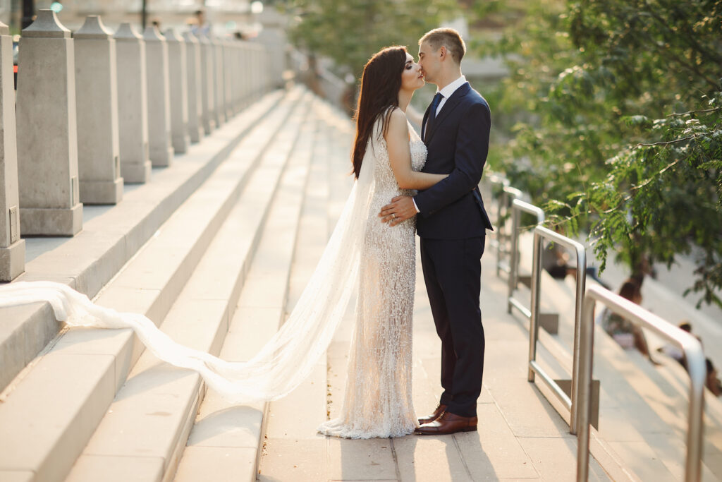 bride and groom kiss on steps
