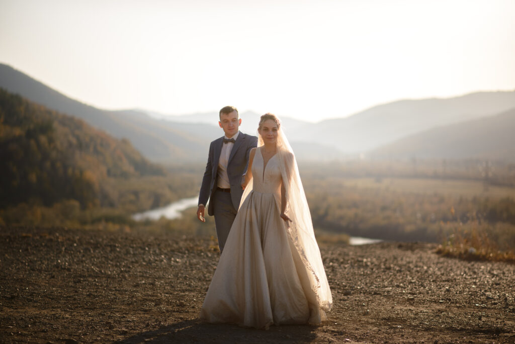 bride and groom pose in the mountains