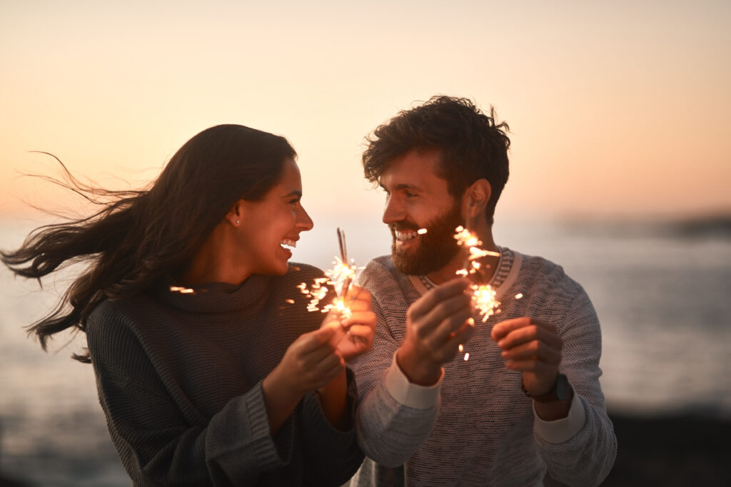 happy young couple having fun with sparklers