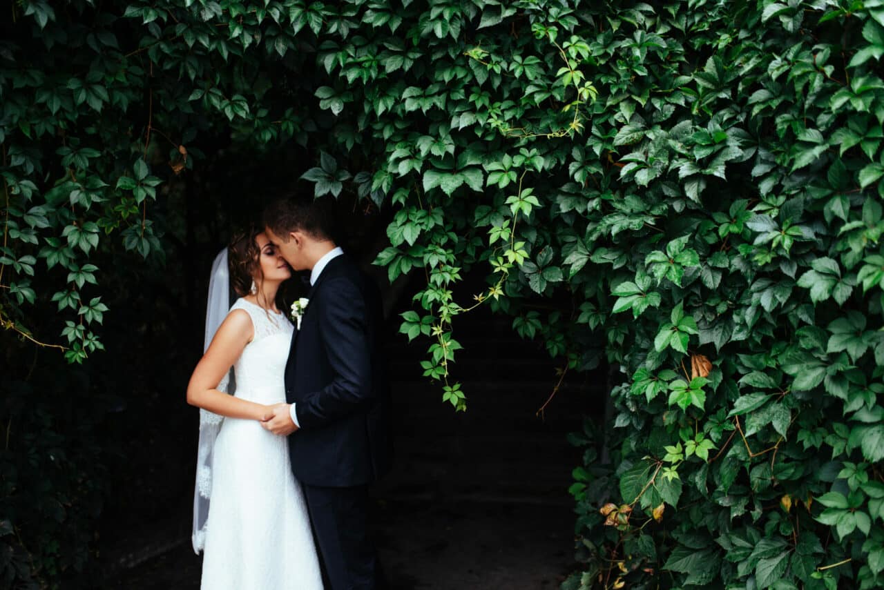 bride and groom kiss outdoors