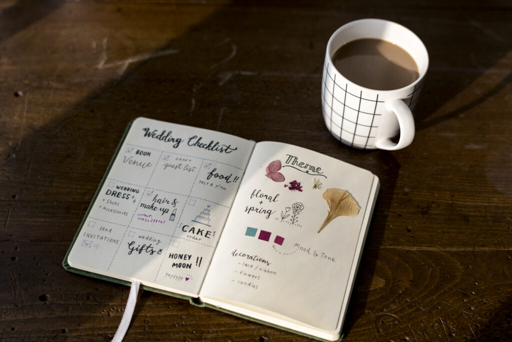 Closeup of wedding checklist notebook on wooden table