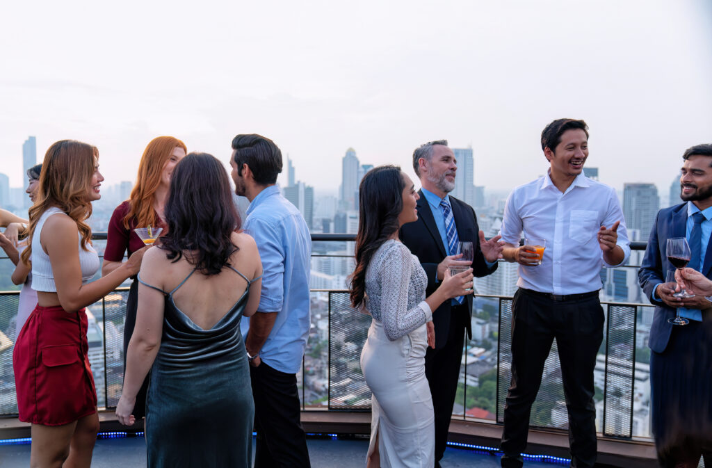 people drinking and socializing on rooftop