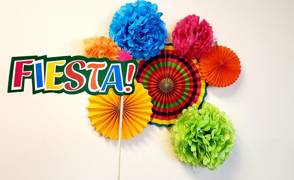 colorful paper fiesta decorations hanging on wall