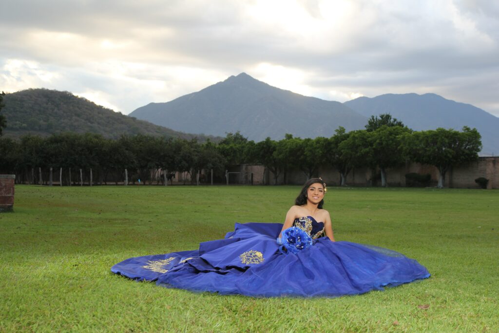 girl posing in blue quinceañera dress
