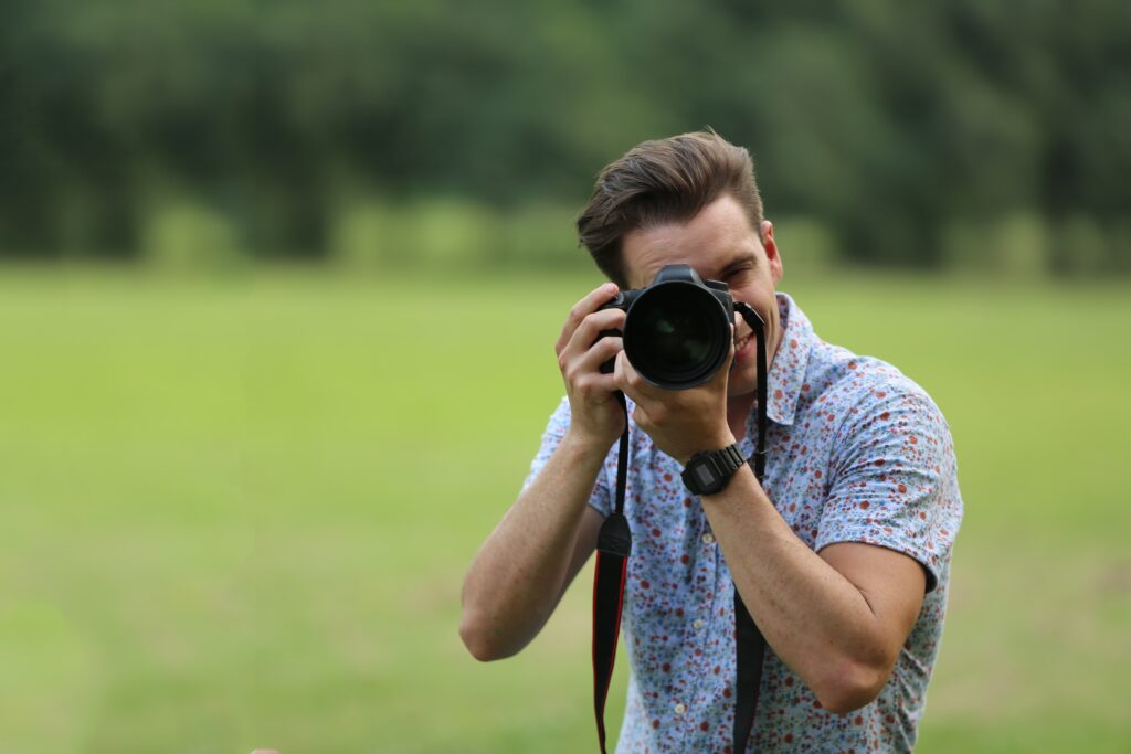 male professional photographer in field