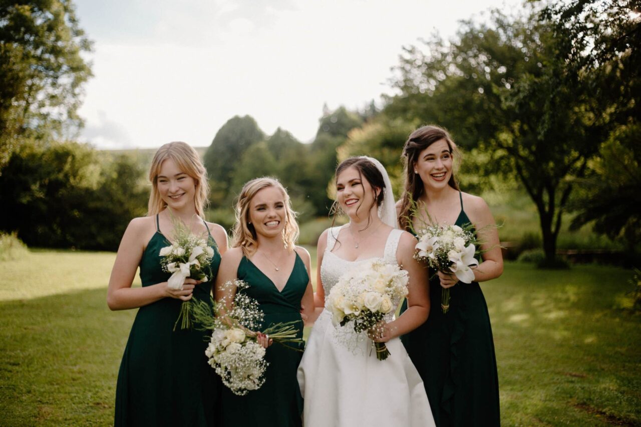 bride with bridesmaids outside
