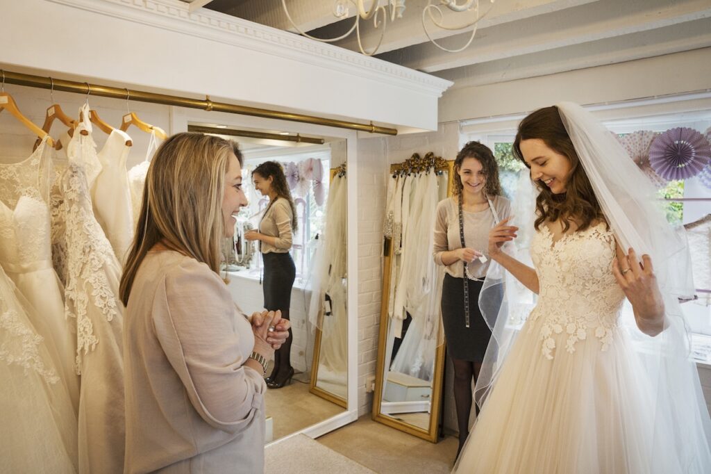 a bride trying on a dress with family