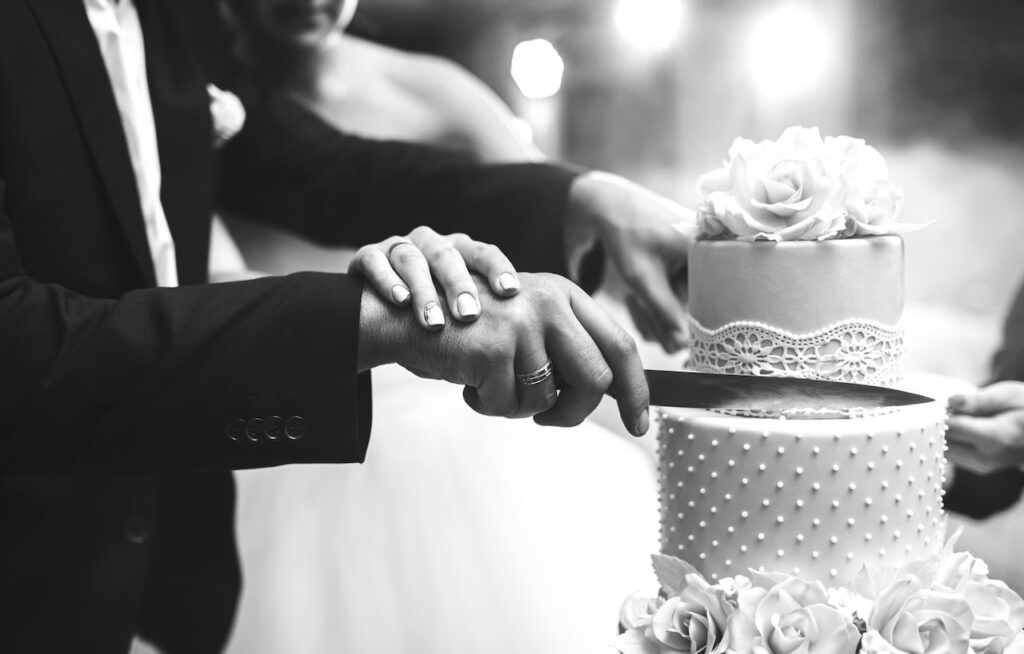 black and white photo of cake cutting wedding tradition