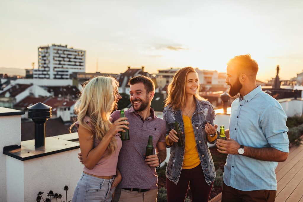 friends drink together on rooftop