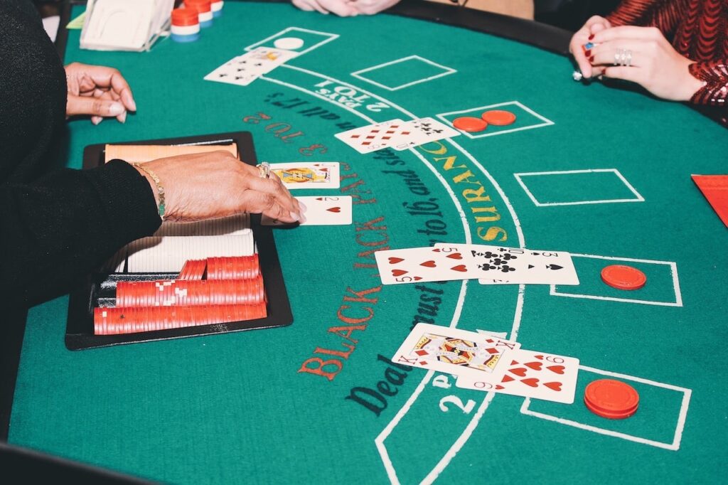 a blackjack dealer shows her cards to a table