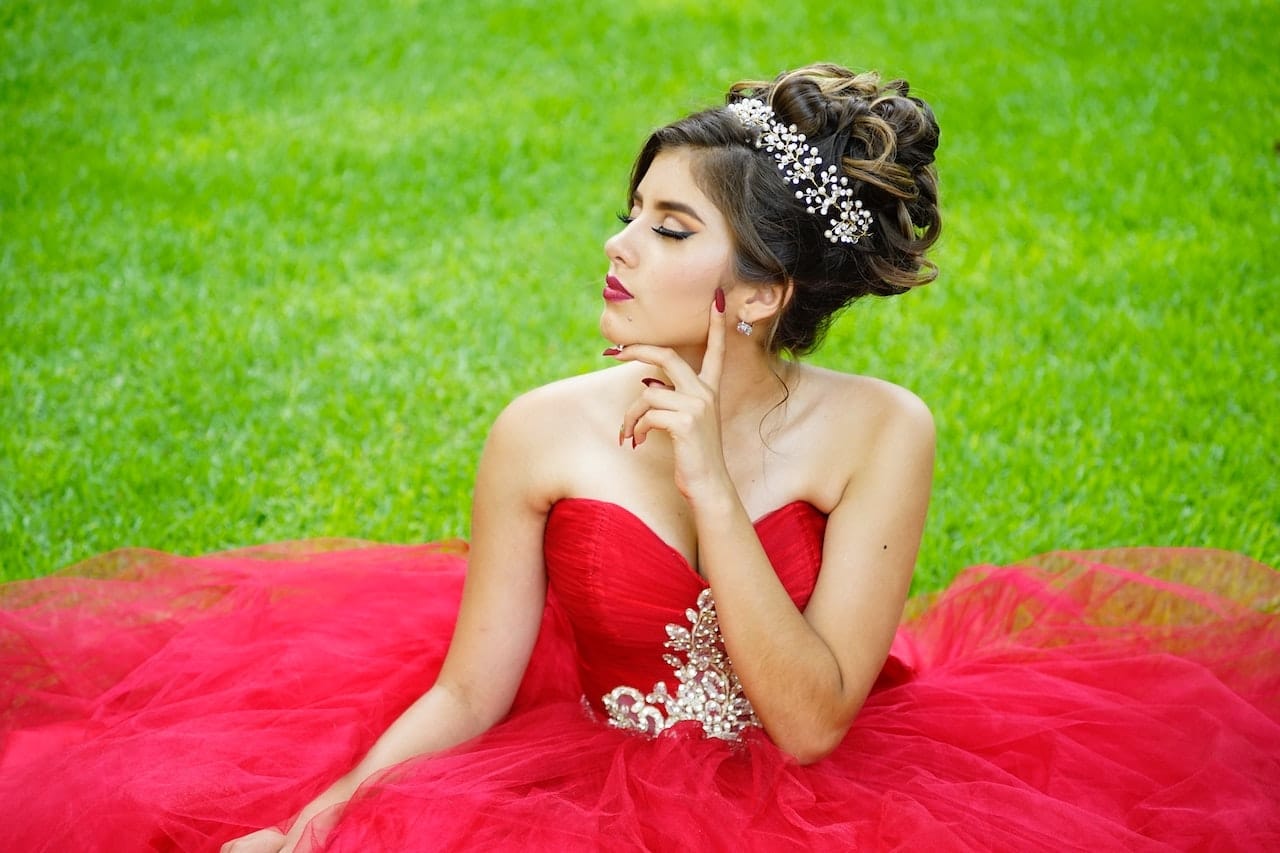 quinceañera posing in red dress