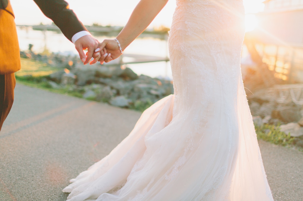 bride and groom running at sunset