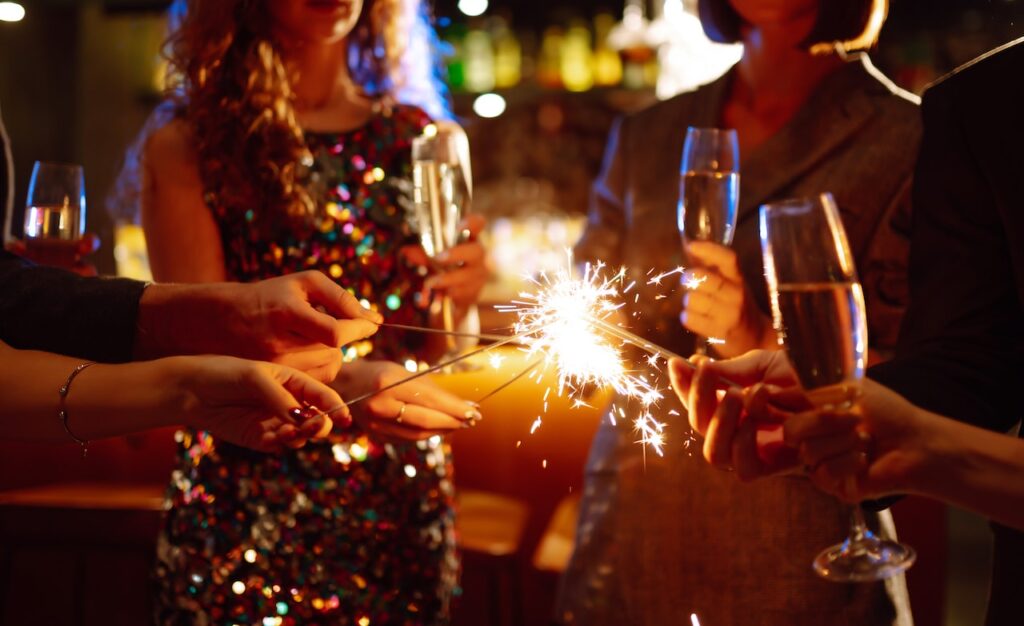 group holding sparklers at holiday party