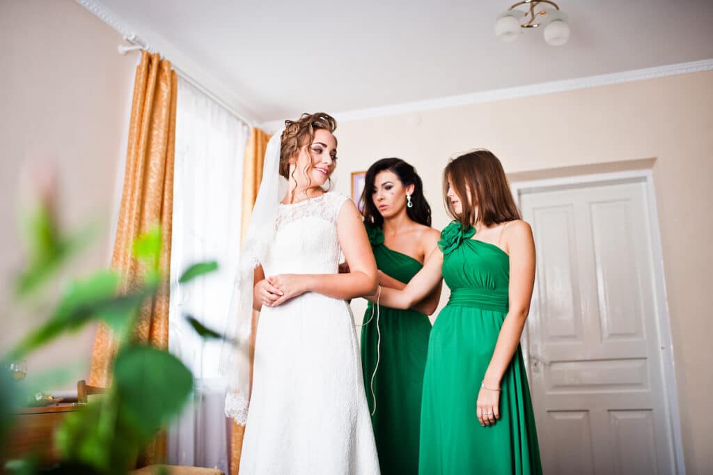 two graceful bridesmaids with green dresses