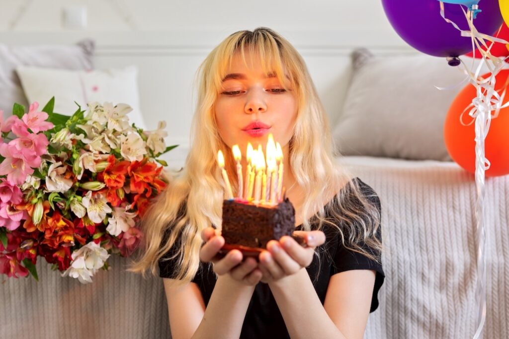 teenager holding small cake at sweet 16