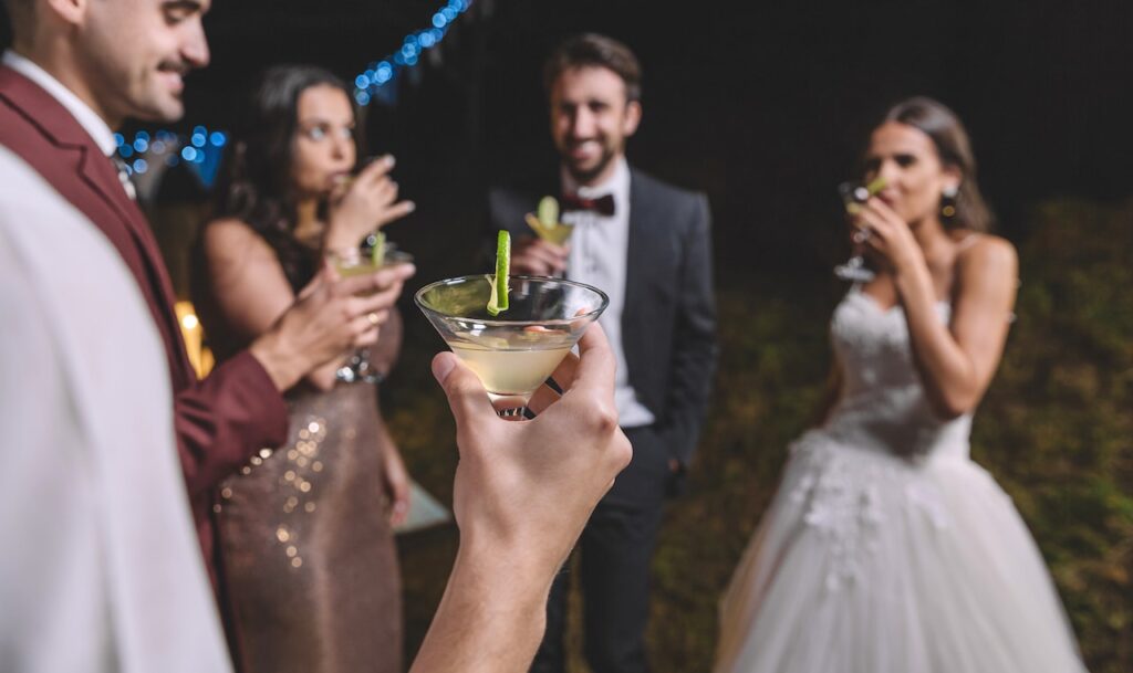 bride drinking cocktails with guests