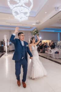 Man and woman cheering after getting married in the Royal Ballroom