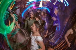 group of teens dancing at quinceanera in event ballroom