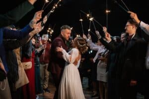 newlyweds walking down tunnel of people holding sparklers