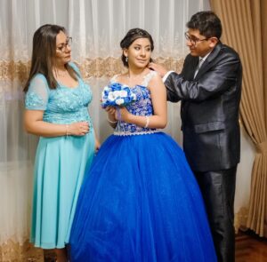 daughter and parents preparing for quinceanera event