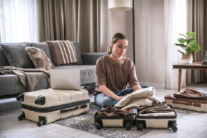 woman packing luggage in suitcase