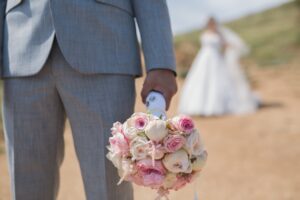 the groom waiting for the bride on dirt trail