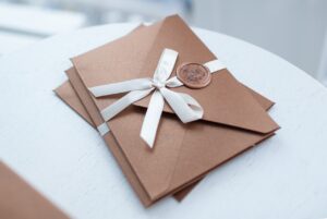 brown quinceanera invitation in envelope with bow