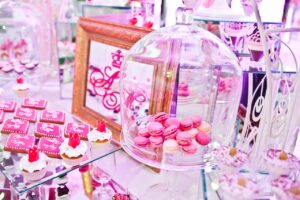 dessert table with bright pink decor for quinceanera